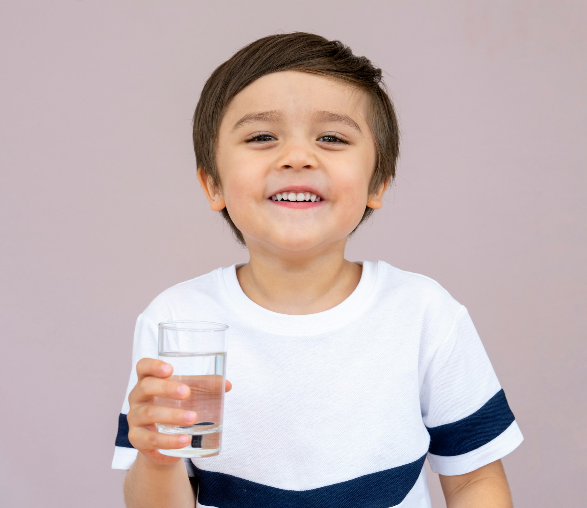 Kid drinking water, Health Child boy holding glass of clear water, Children Healthy care concept